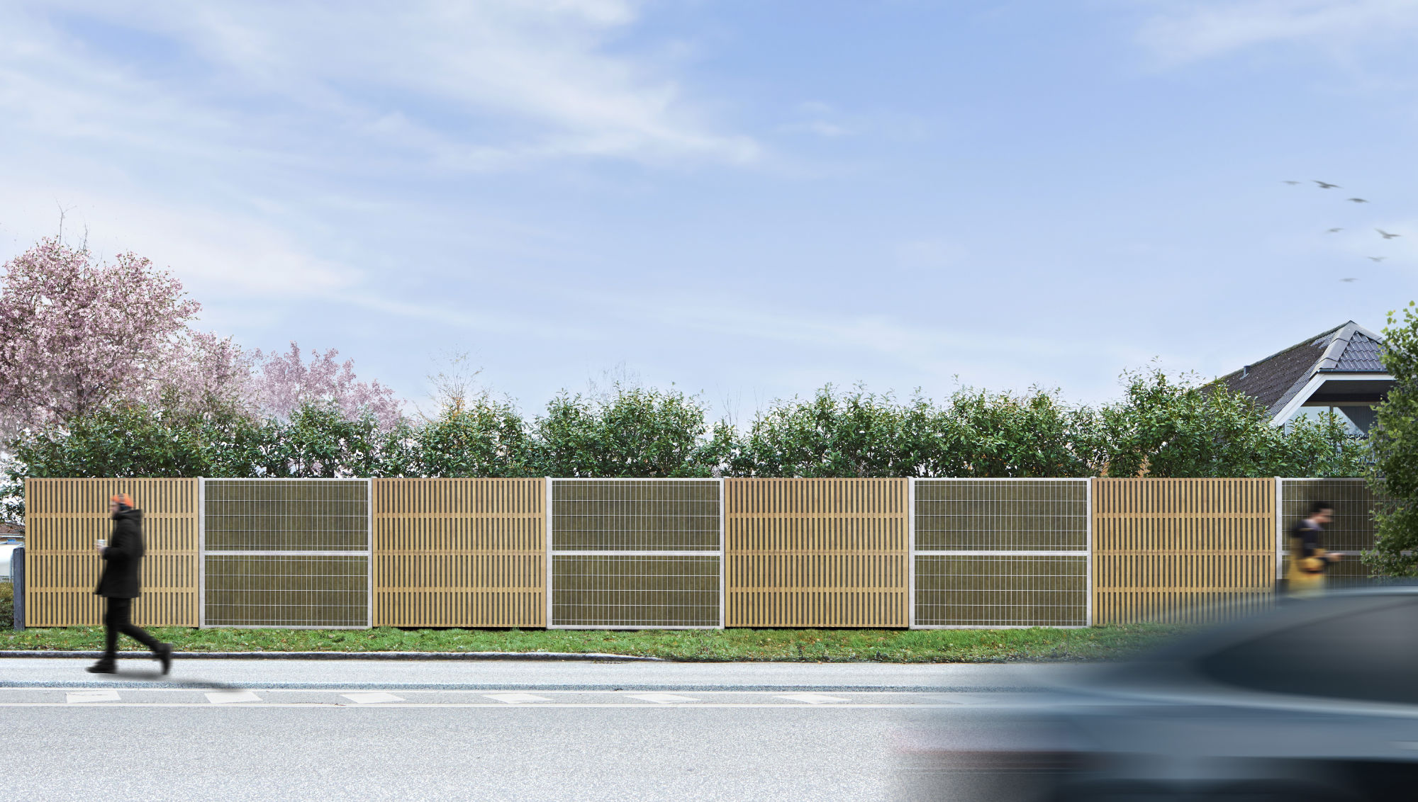 Noistop Essential Lärmschutzzaun mit verzinktem Stahlrahmen und Metallpaneelen, teilweise mit hellen Holzlamellen verkleidet. Ein Fußgänger geht vorbei, und ein Auto fährt vorbei.