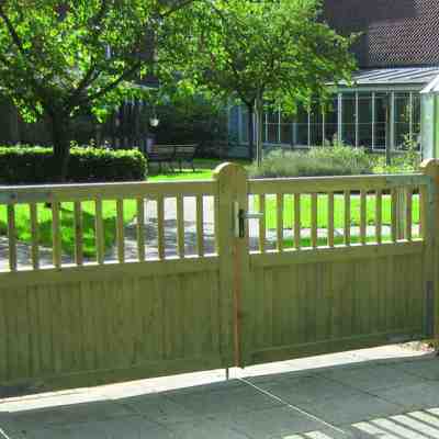 Im Vordergrund ist ein Country Garden, im Hintergrund ein Garten mit Gewächshaus